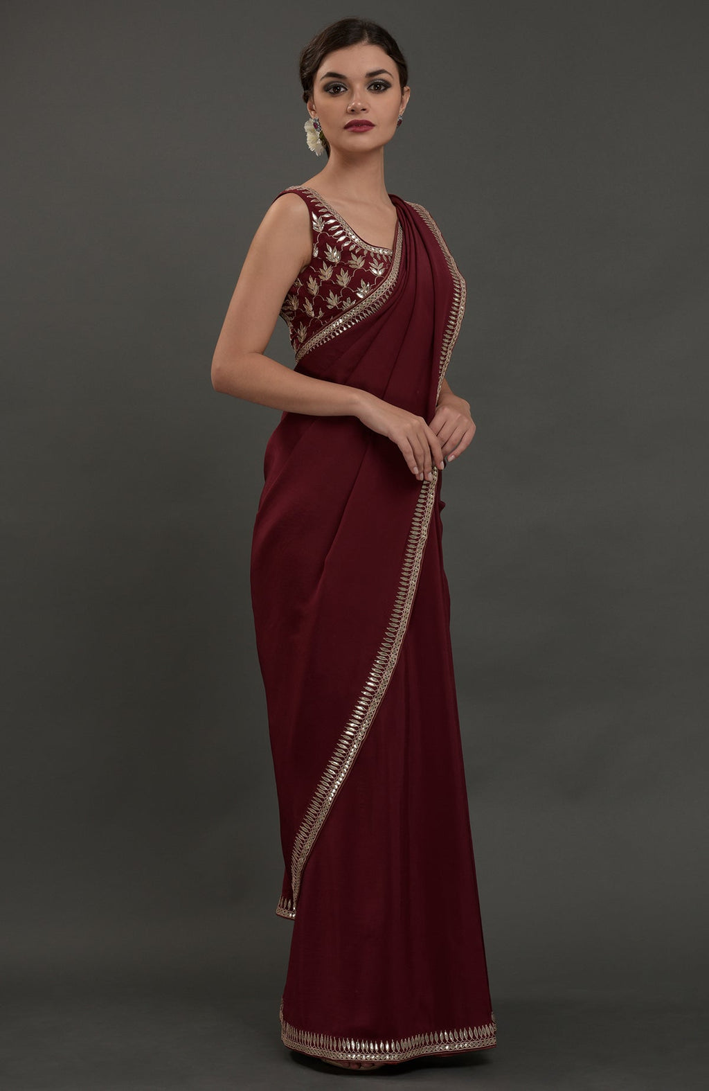 Burgundy crepe saree with silvery gold gota patti embroidery.