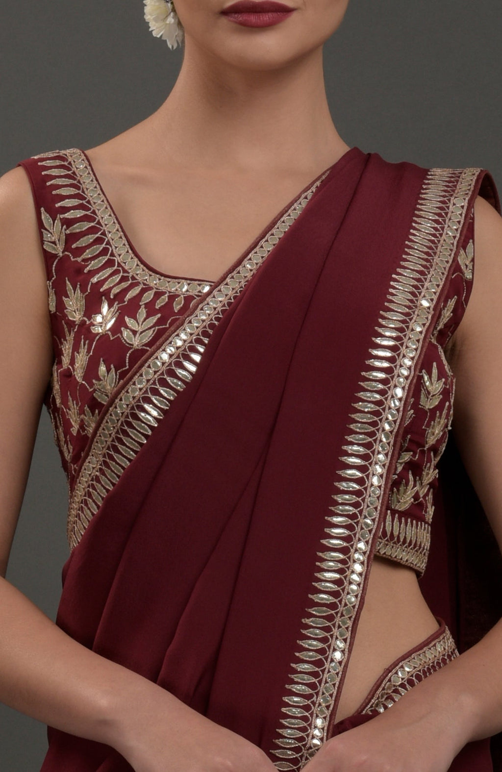 Burgundy crepe saree with silvery gold gota patti embroidery on the borders and blouse.