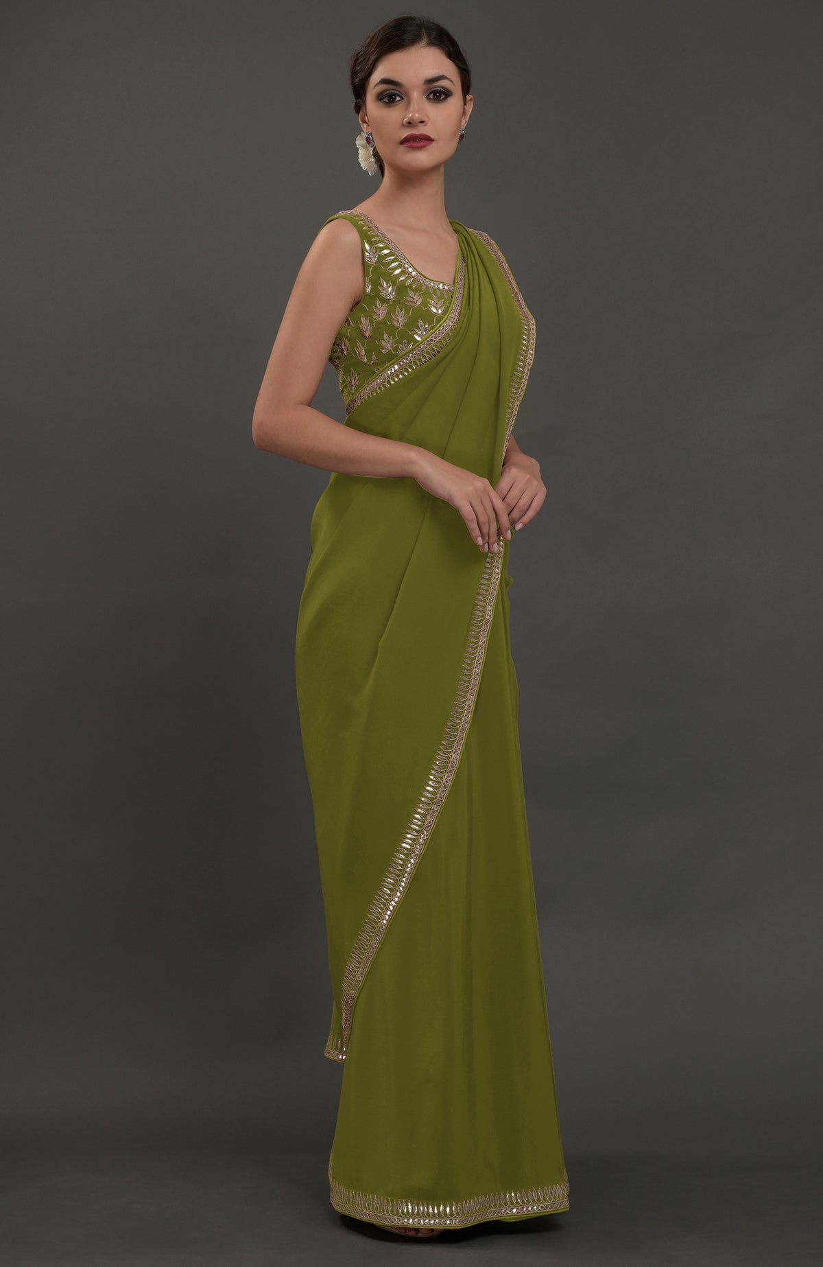 Avocado green embroidered gota patti saree with a matching sleeveless blouse.