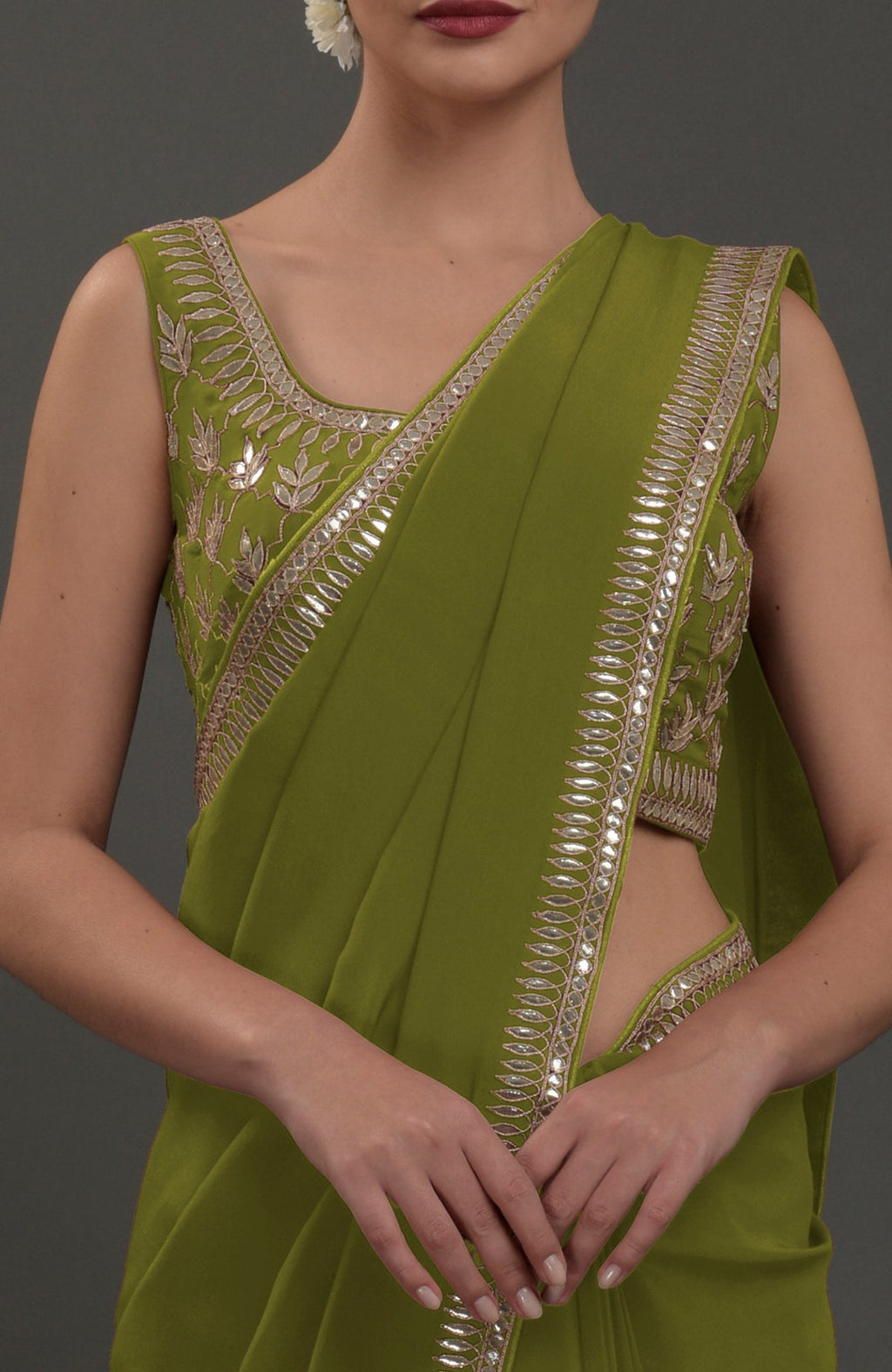 Avocado green embroidered gota patti saree with a matching sleeveless blouse.