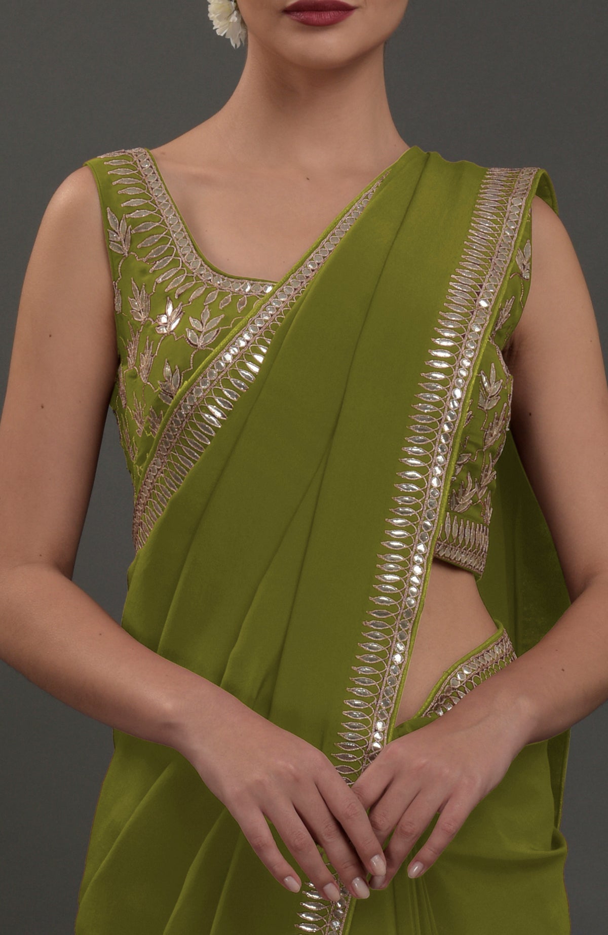 Avocado green embroidered gota patti saree with a matching sleeveless blouse.