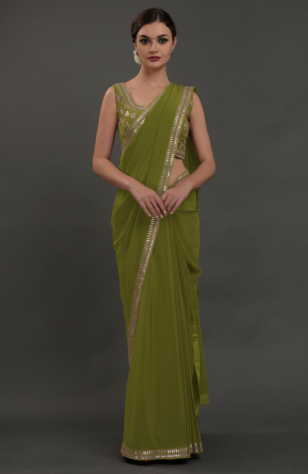 Avocado green embroidered gota patti saree with a matching sleeveless blouse.