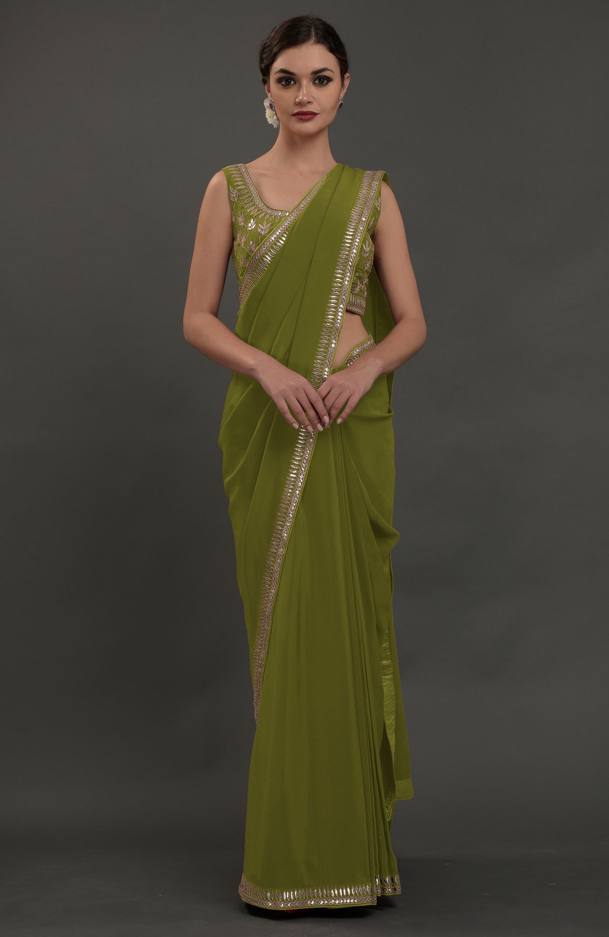 Avocado green embroidered gota patti saree with a matching sleeveless blouse.