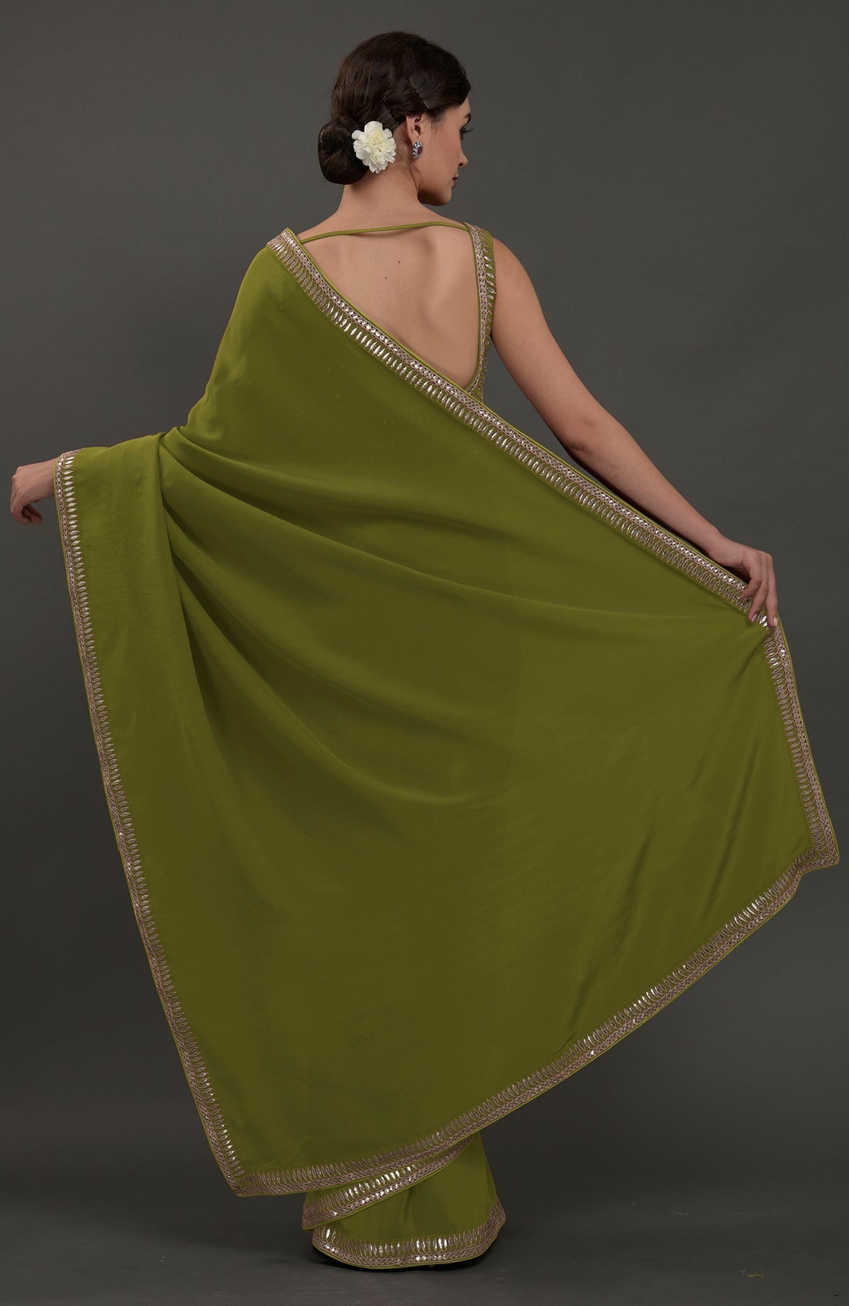 Avocado green embroidered gota patti saree with a deep back blouse.
