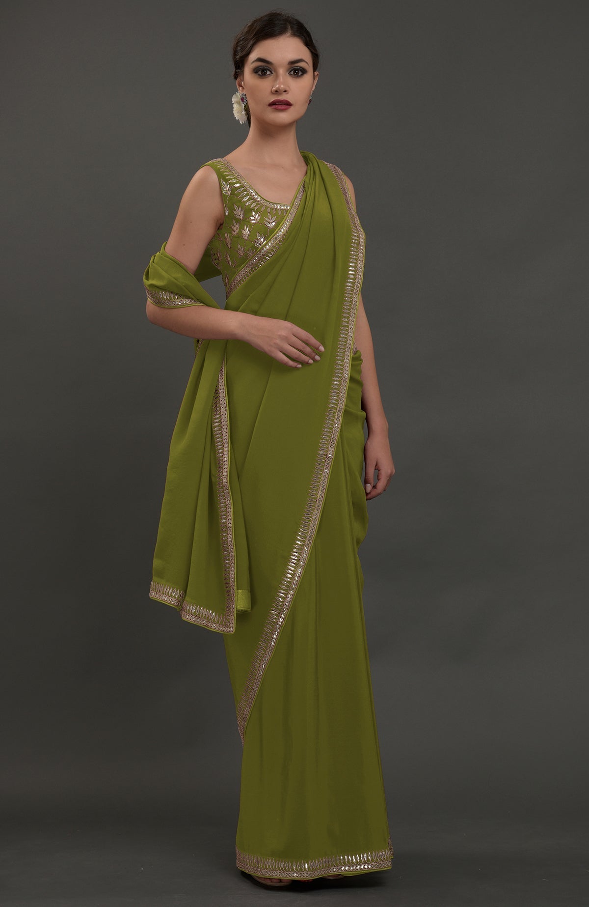 Avocado green embroidered gota patti saree with a matching sleeveless blouse.