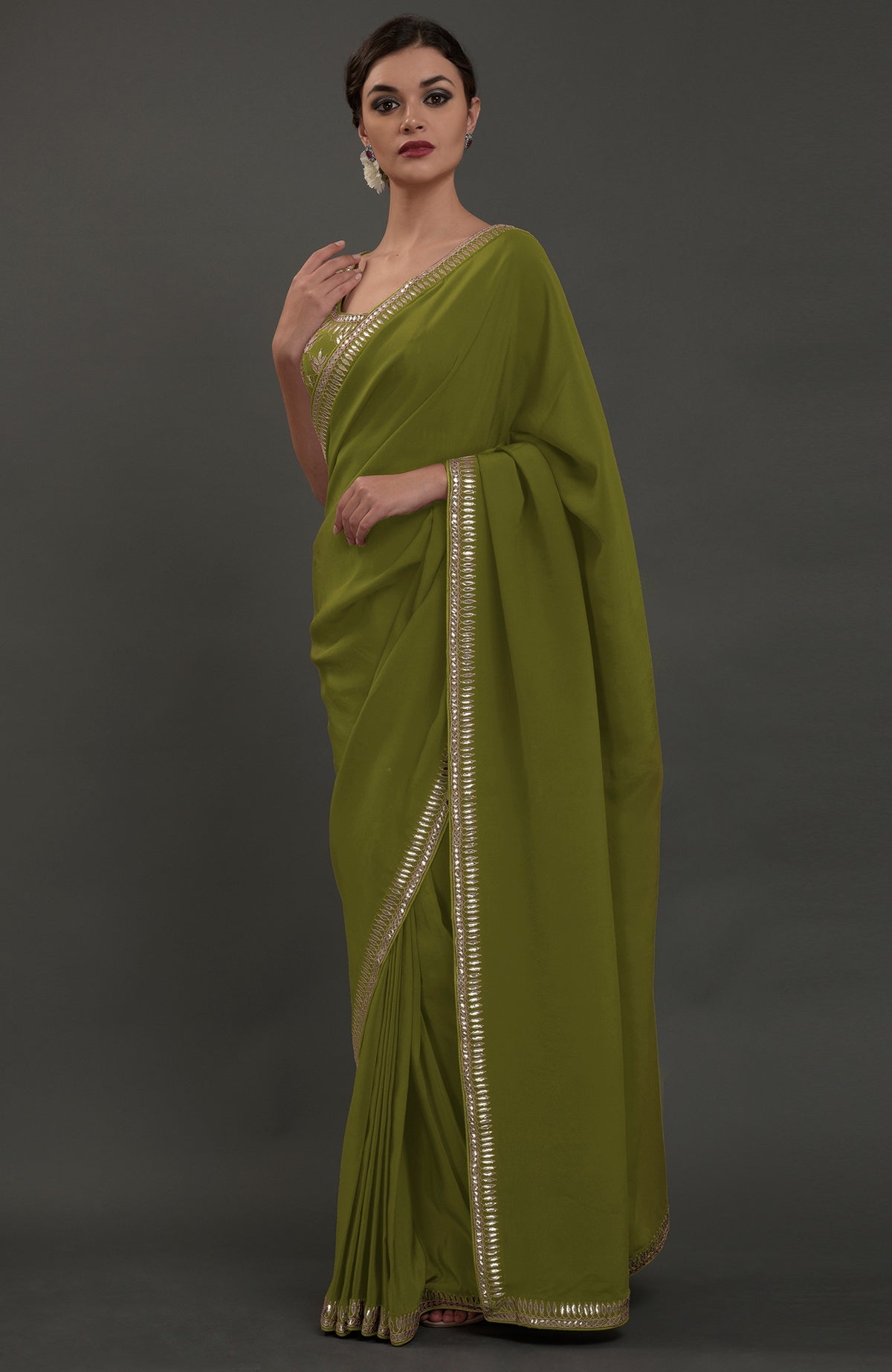 Avocado green embroidered gota patti saree with a matching blouse.