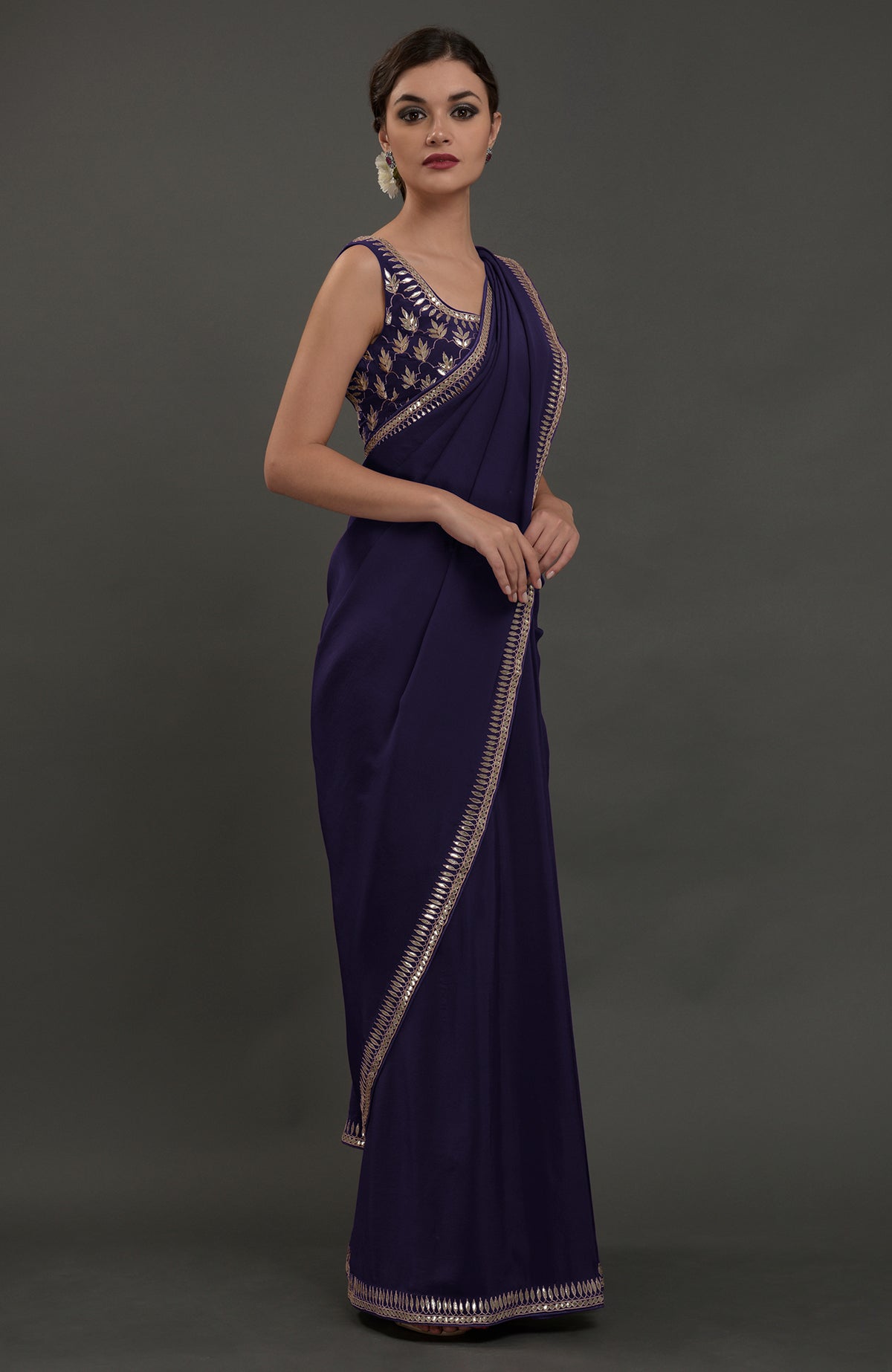 An eclipse blue crepe saree with silvery gold gota patti embroidery.