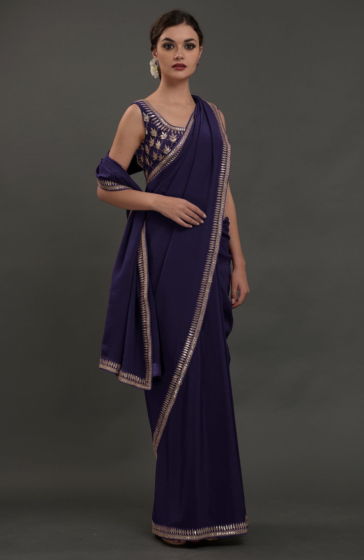 Eclipse blue crepe saree with silvery gold gota patti embroidery and matching blouse.