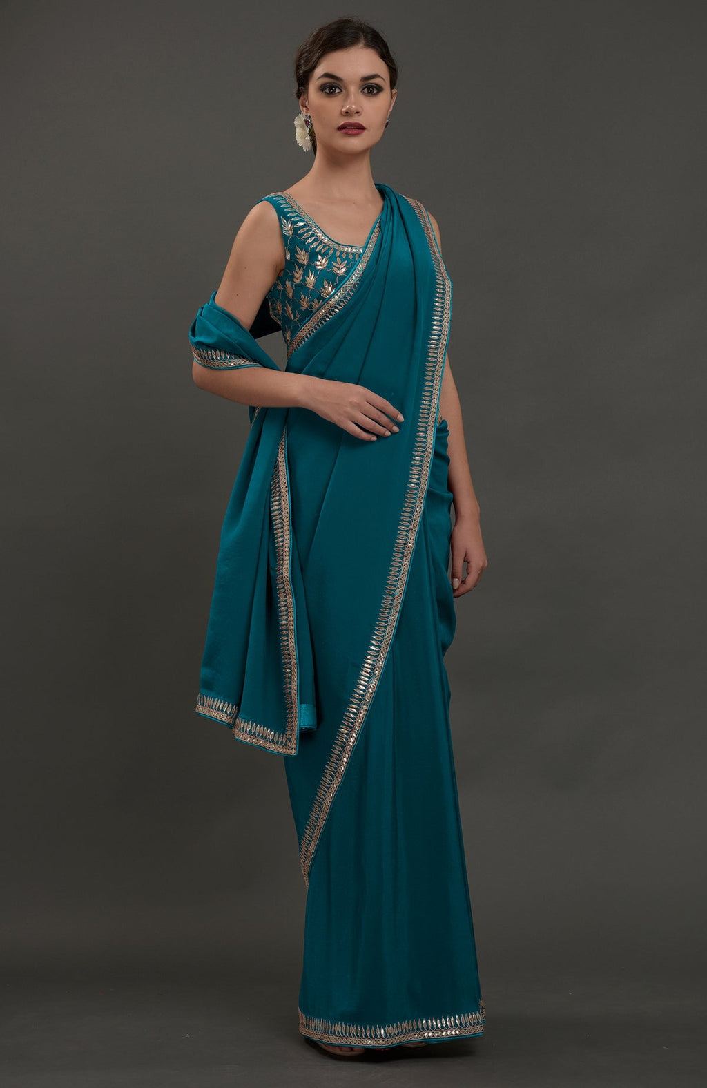 Oceanside blue crepe saree with silvery gold gota patti embroidery.
