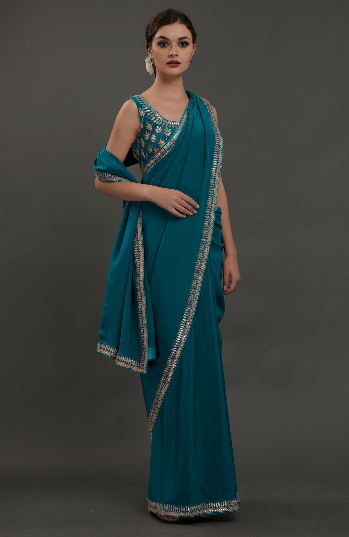 Oceanside blue crepe saree with silvery gold gota patti embroidery.