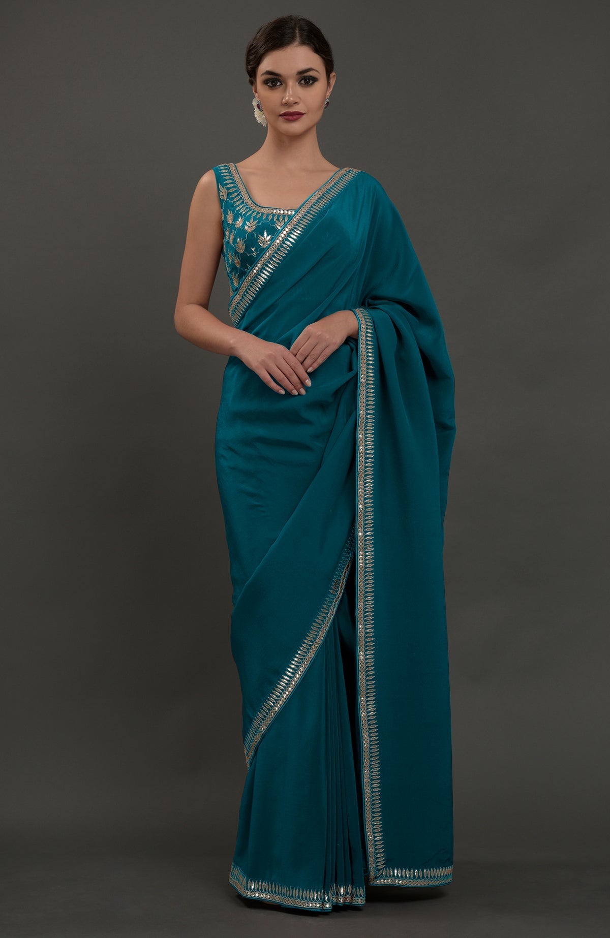 Eclipse blue embroidered gota patti saree with a matching sleeveless blouse.
