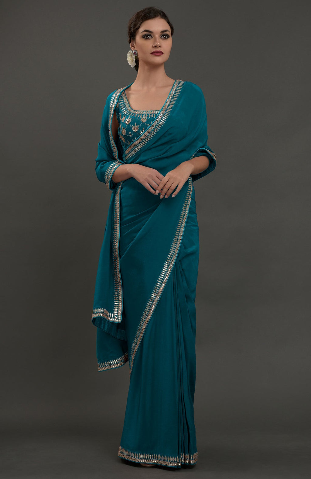 Oceanside blue embroidered gota patti saree with a matching blouse.