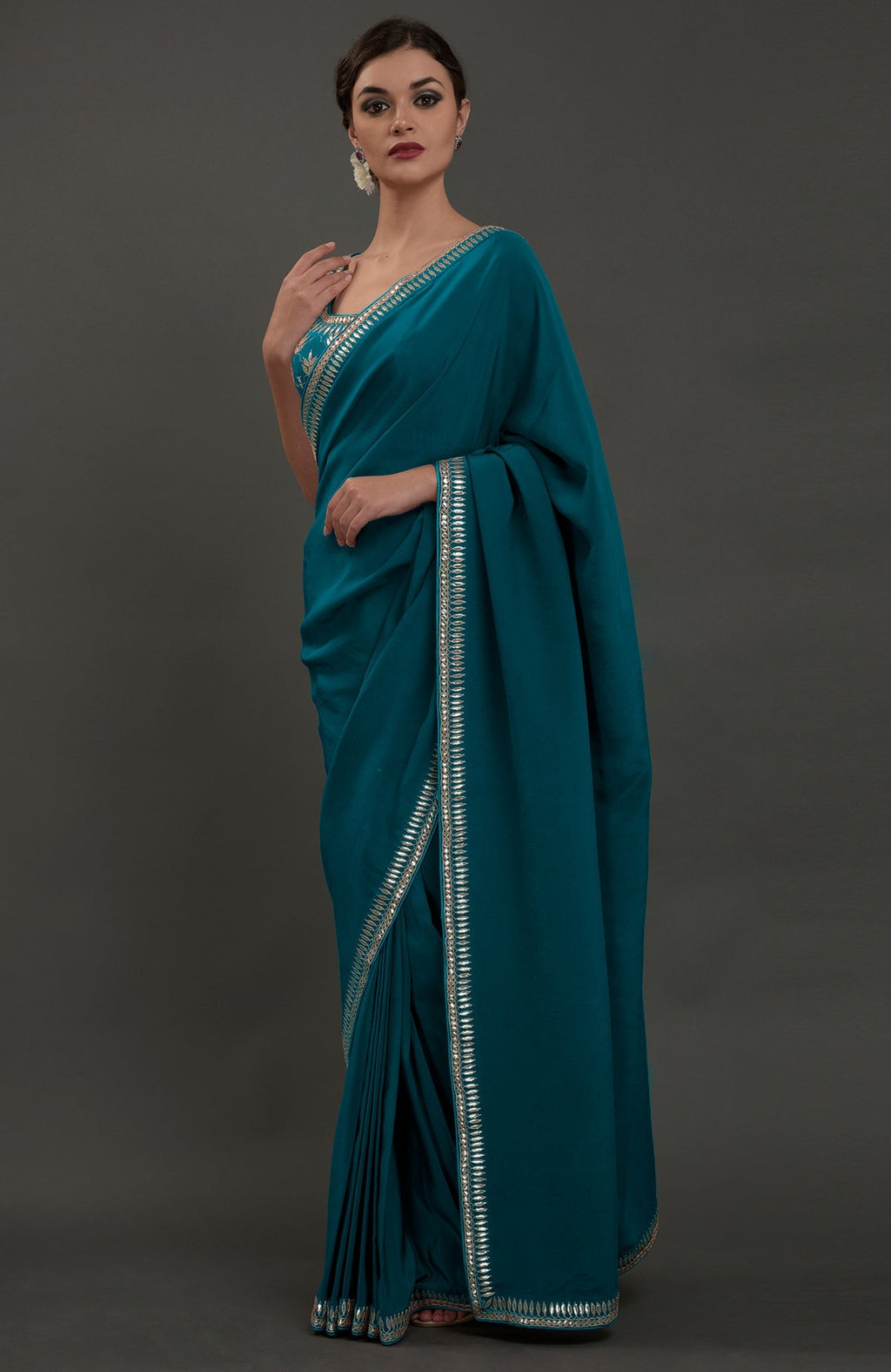 Oceanside blue embroidered gota patti saree with a matching blouse.