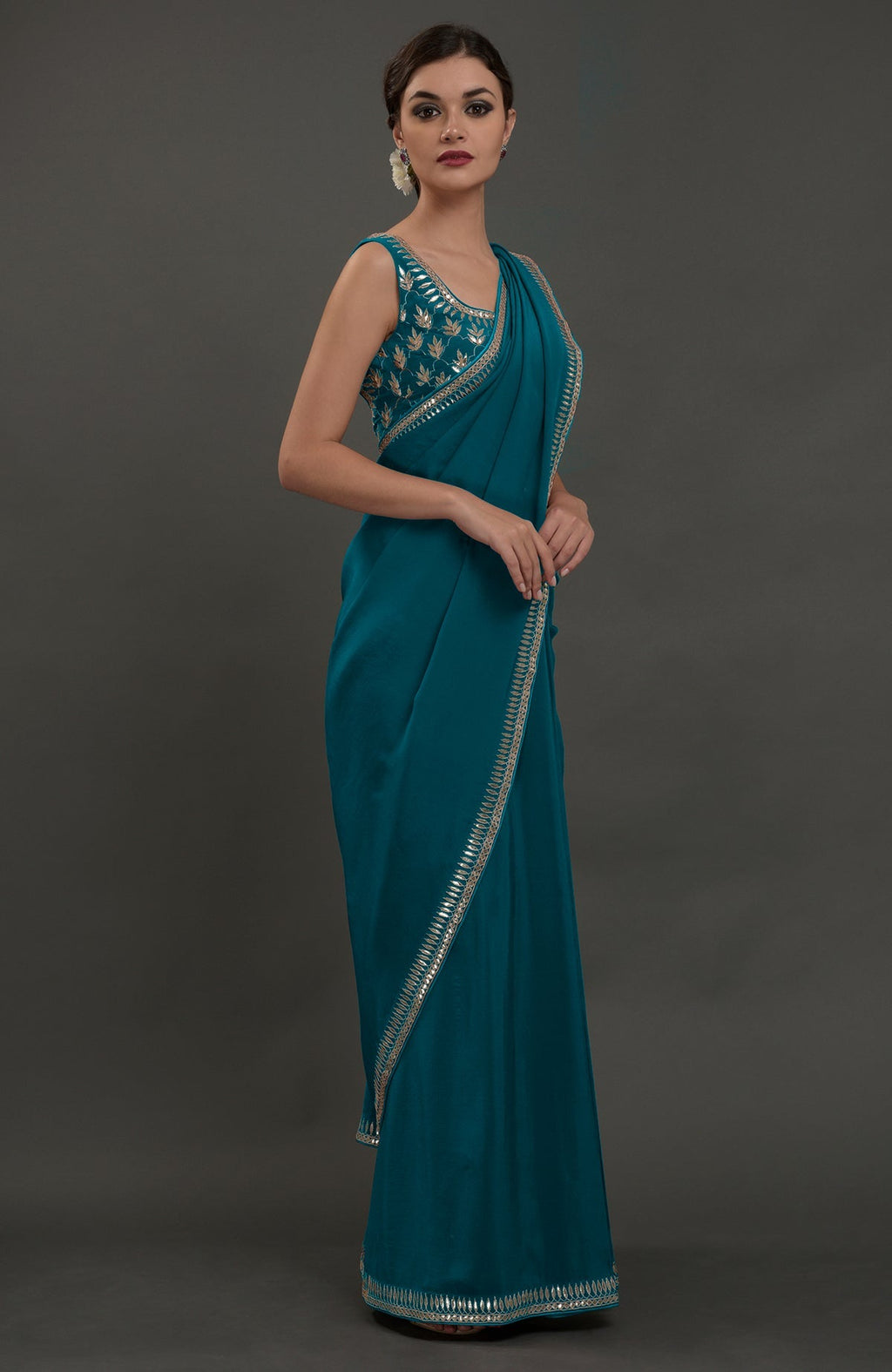 Oceanside blue embroidered gota patti saree with a matching sleeveless blouse.