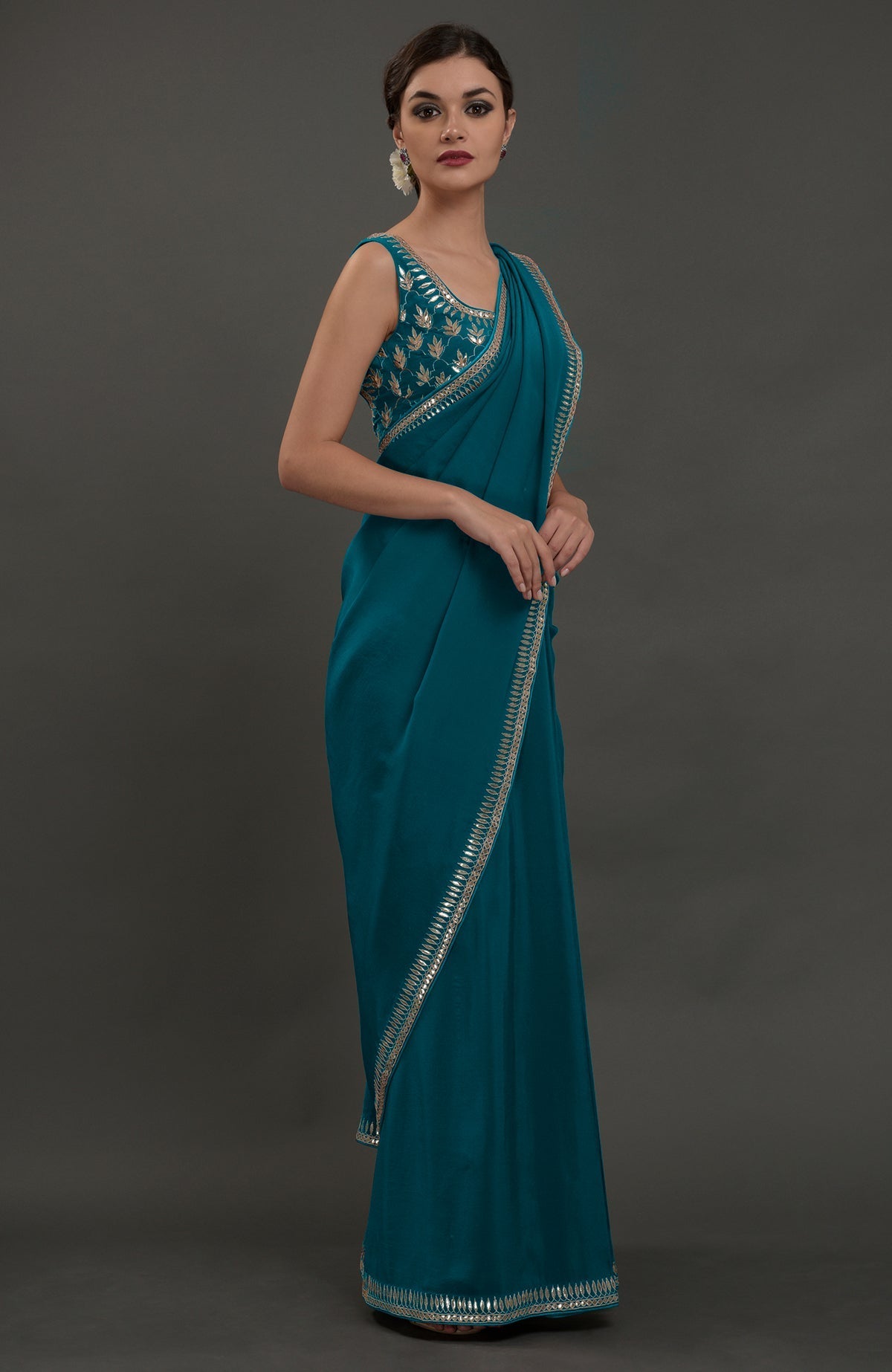 Oceanside blue embroidered gota patti saree with a matching sleeveless blouse.