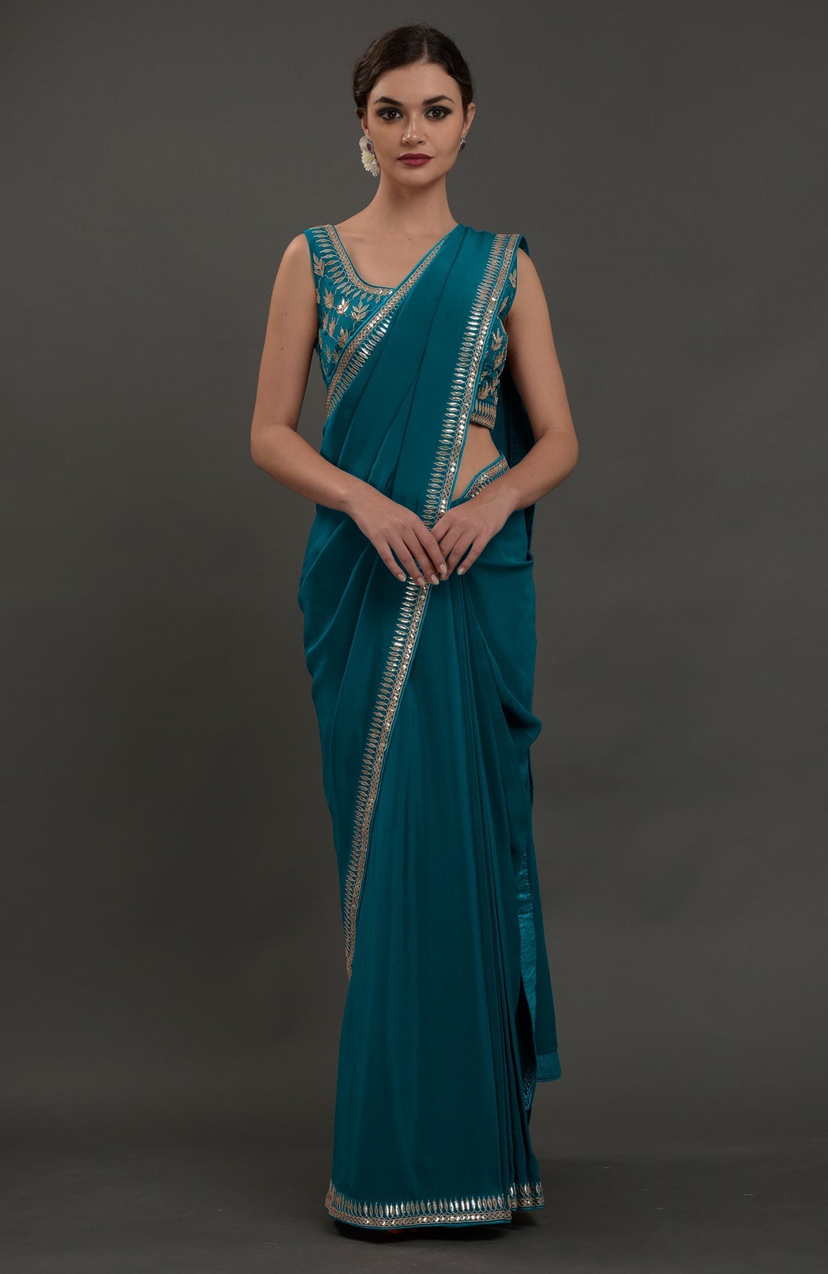 Oceanside blue embroidered gota patti saree with a matching sleeveless blouse.