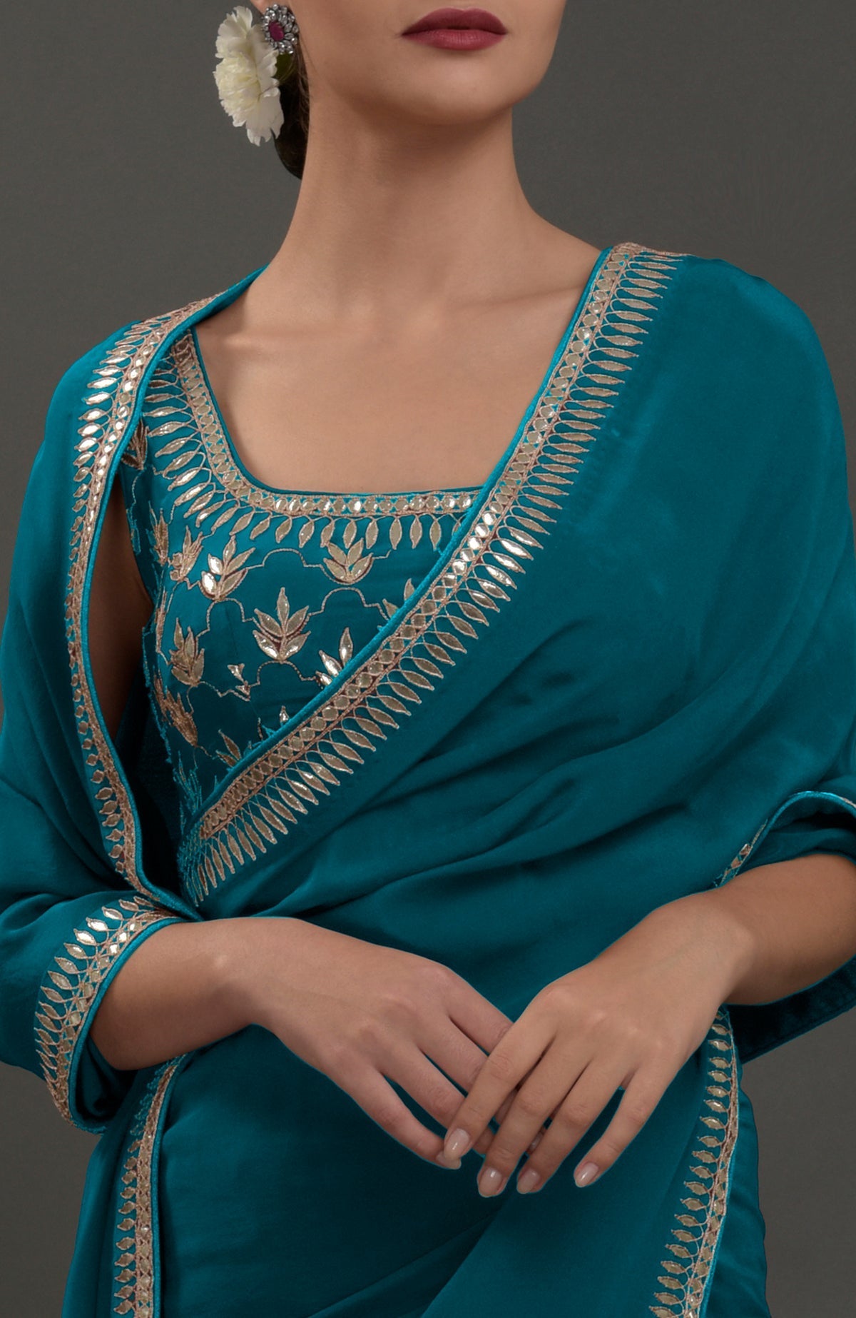 Oceanside blue crepe saree with intricate silvery gold gota patti embroidery.