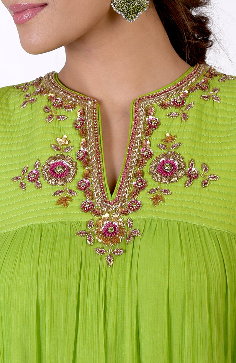 Green tiered dress with zardozi and resham hand embroidery on the neckline.