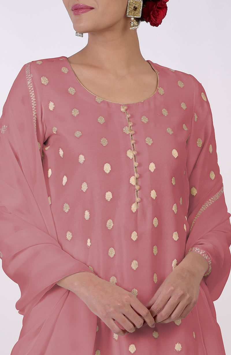 A woman models a withered rose Banarasi bootah and Aari Tilla embroidered sharara set.