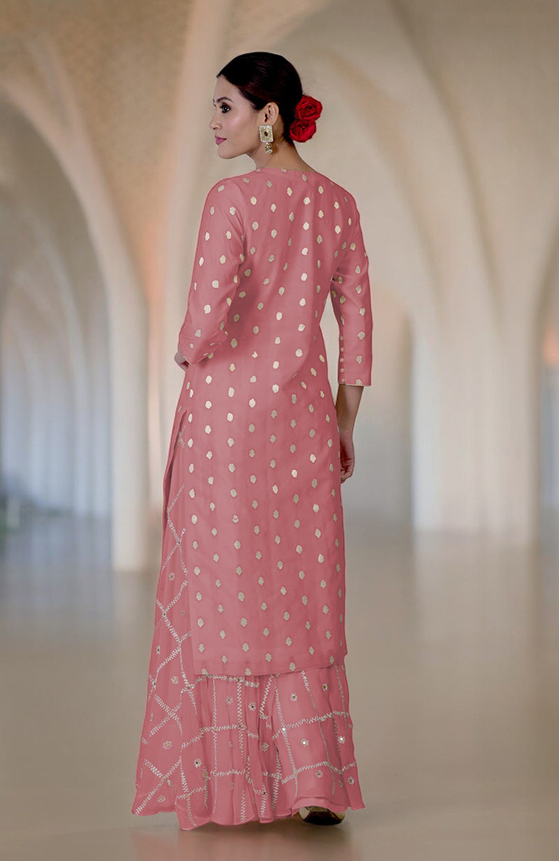 A woman in a withered rose Banarasi bootah and aari tilla embroidered sharara set.