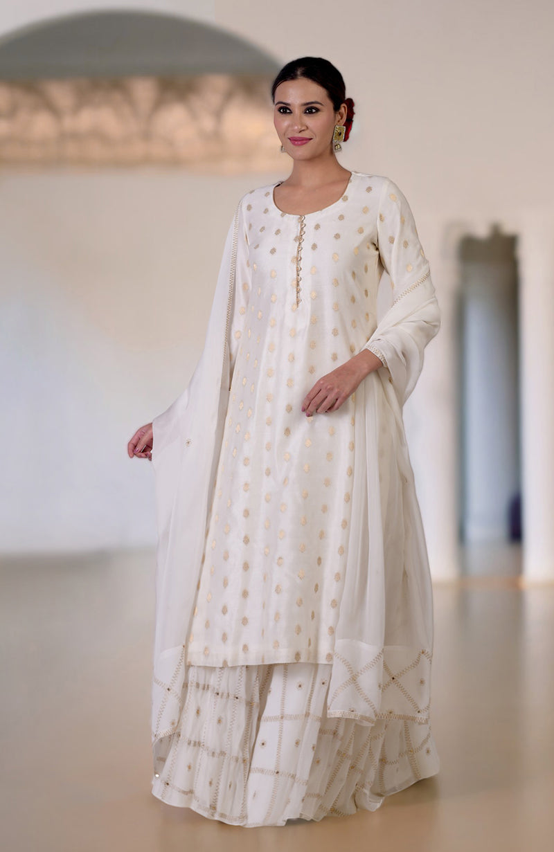 Ivory Banarasi kurta with gold bootah, aari tilla embroidered sharara, and sequined dupatta.