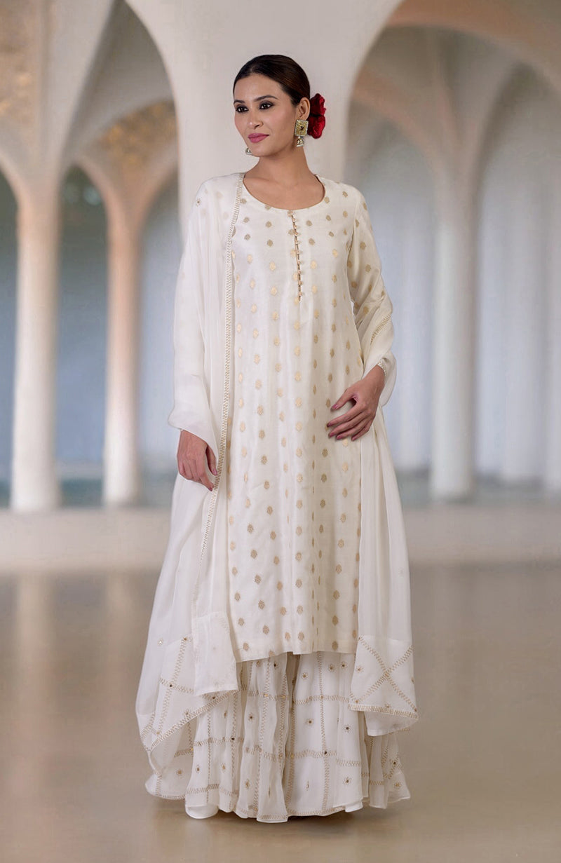 Ivory Banarasi sharara set with gold bootah kurta, embroidered sharara, and sequined dupatta.