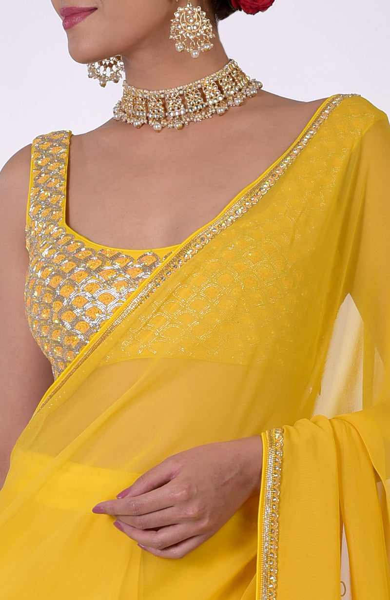 Daffodil yellow hand-embroidered saree with a beaded blouse and delicate border.