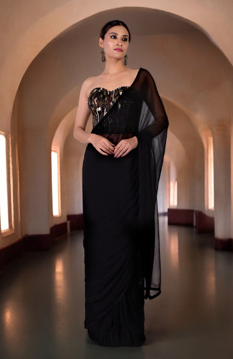 A woman models a black hand-embroidered corset and matching saree.