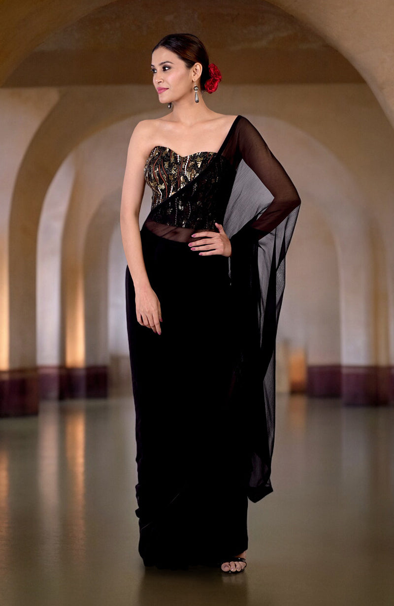 A woman models a black hand-embroidered corset and matching saree.