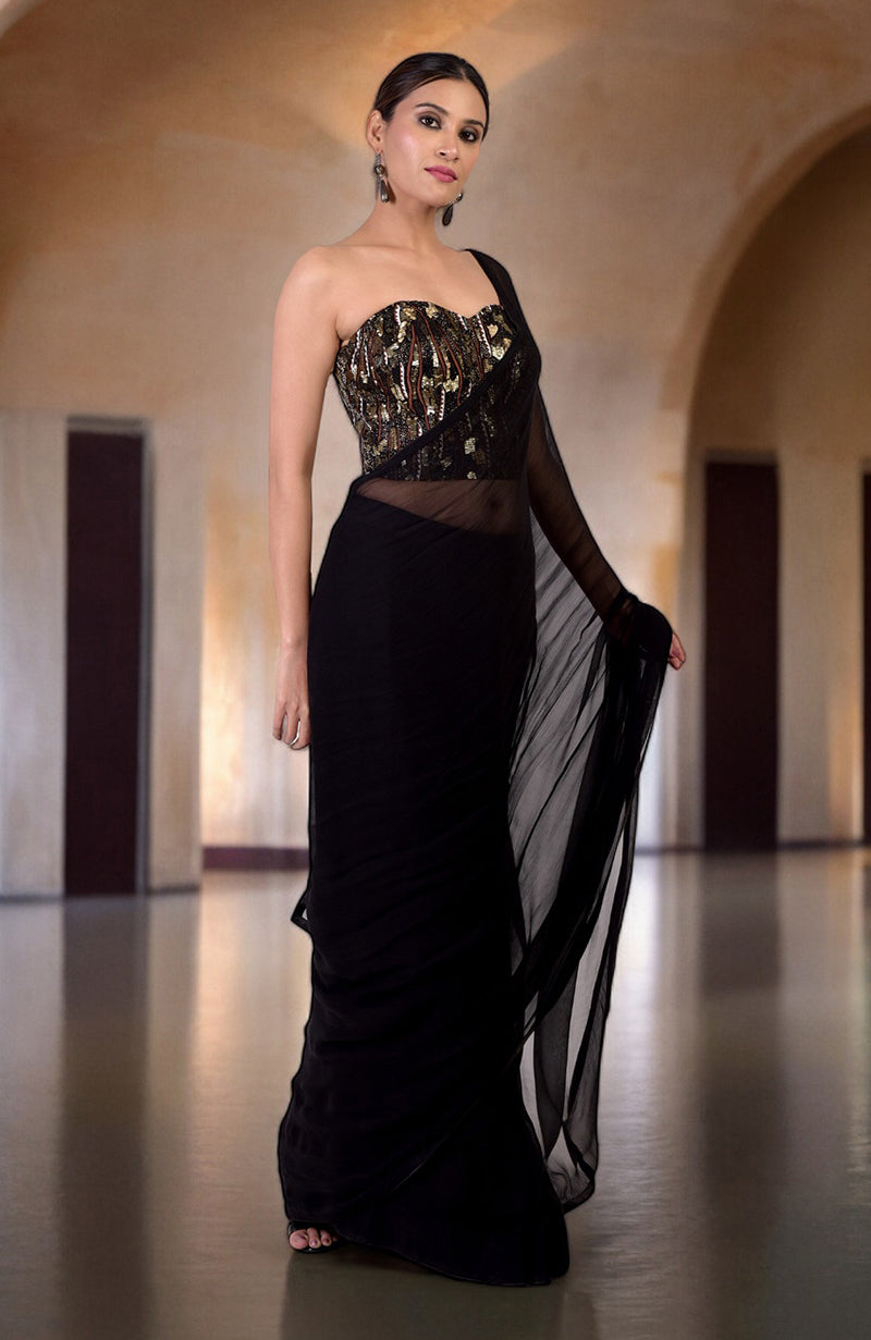 A woman models a black saree with a hand-embroidered corset.