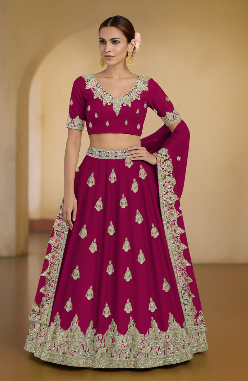 Bright rose lehenga set with Kashmiri tilla and zardozi embroidery and green accents.