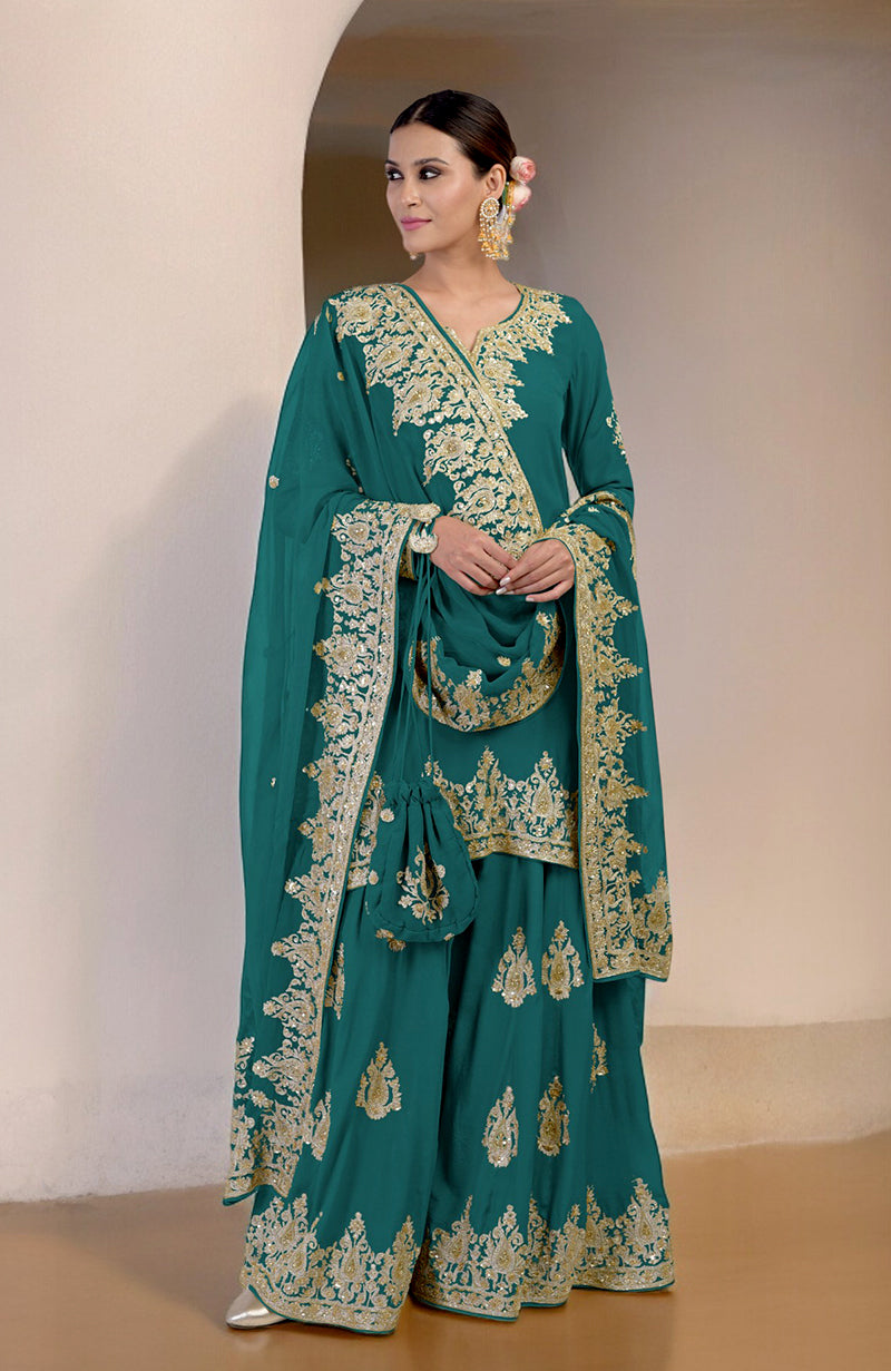 A woman models a teal sharara set with gold embroidery and a matching potli bag.