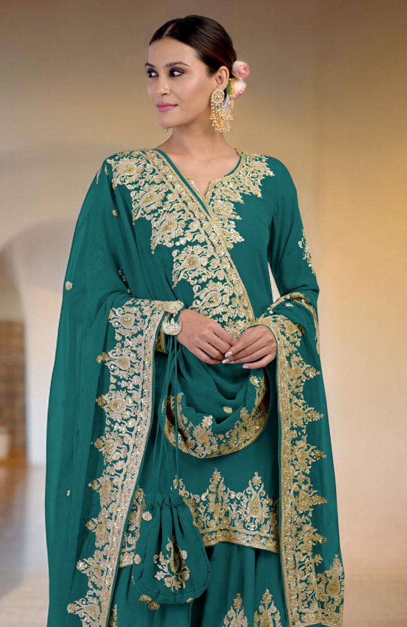 A woman models a teal sharara set with gold embroidery and a matching potli bag.