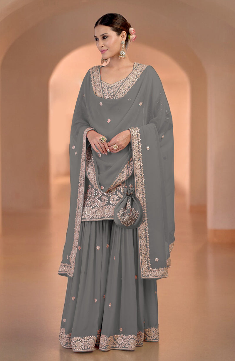 Illusion blue sharara set with marori gota patti and zardozi embroidery, and a matching potli bag.
