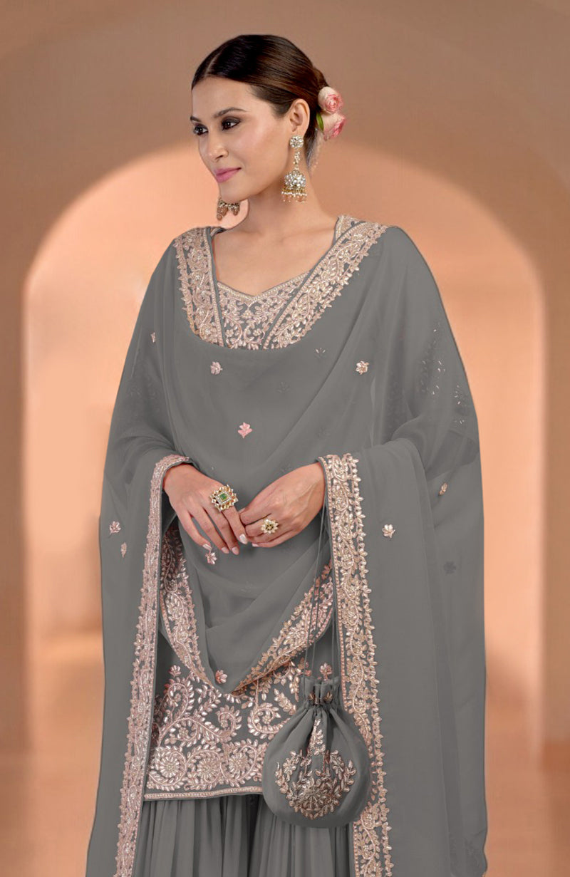 Grey sharara set with intricate embroidery, matching dupatta, and potli bag.