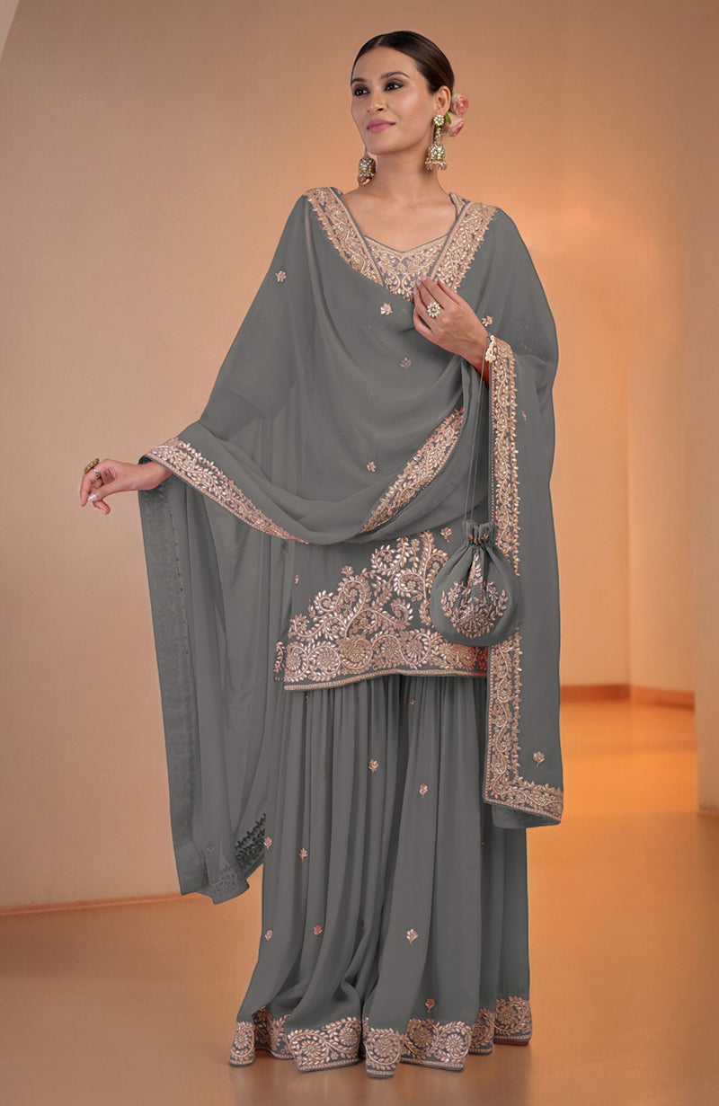 Grey sharara set with intricate embroidery, matching dupatta, and potli bag.