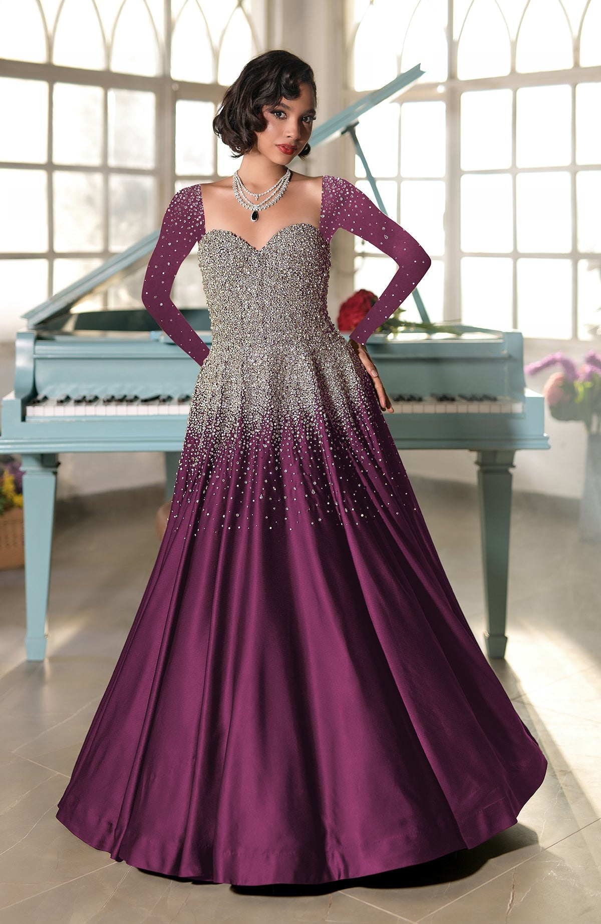 A woman in a purple and silver crystal-embroidered princess gown.