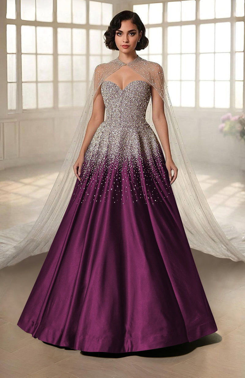 A woman models a purple and silver crystal-embroidered princess gown with a sheer cape.