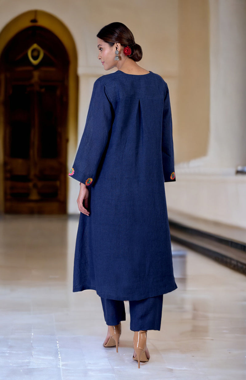 A woman from behind wears a navy blue linen kurta set with embroidered sleeves.