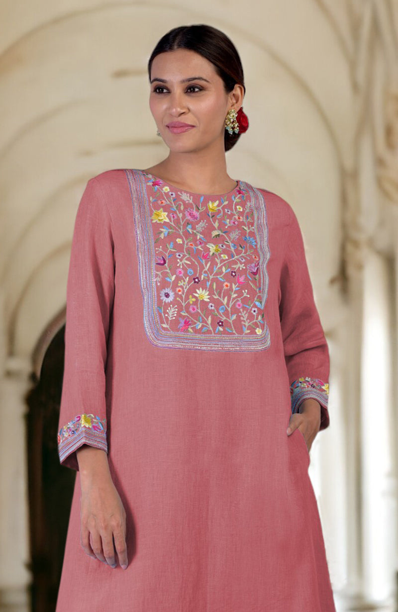 A woman models a desert rose linen kurta with Parsi Gara embroidery.