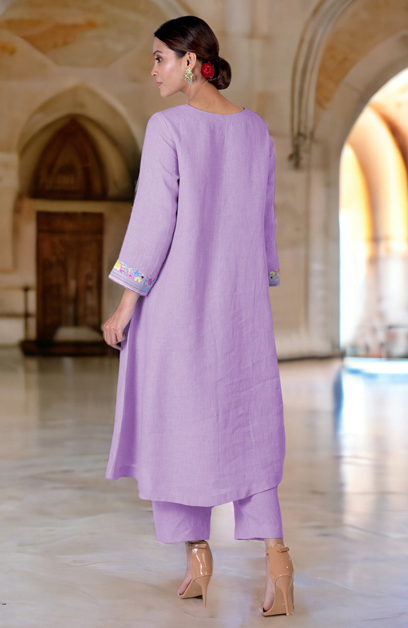 A woman models a lilac linen kurta set with Parsi Gara embroidery on the sleeves.