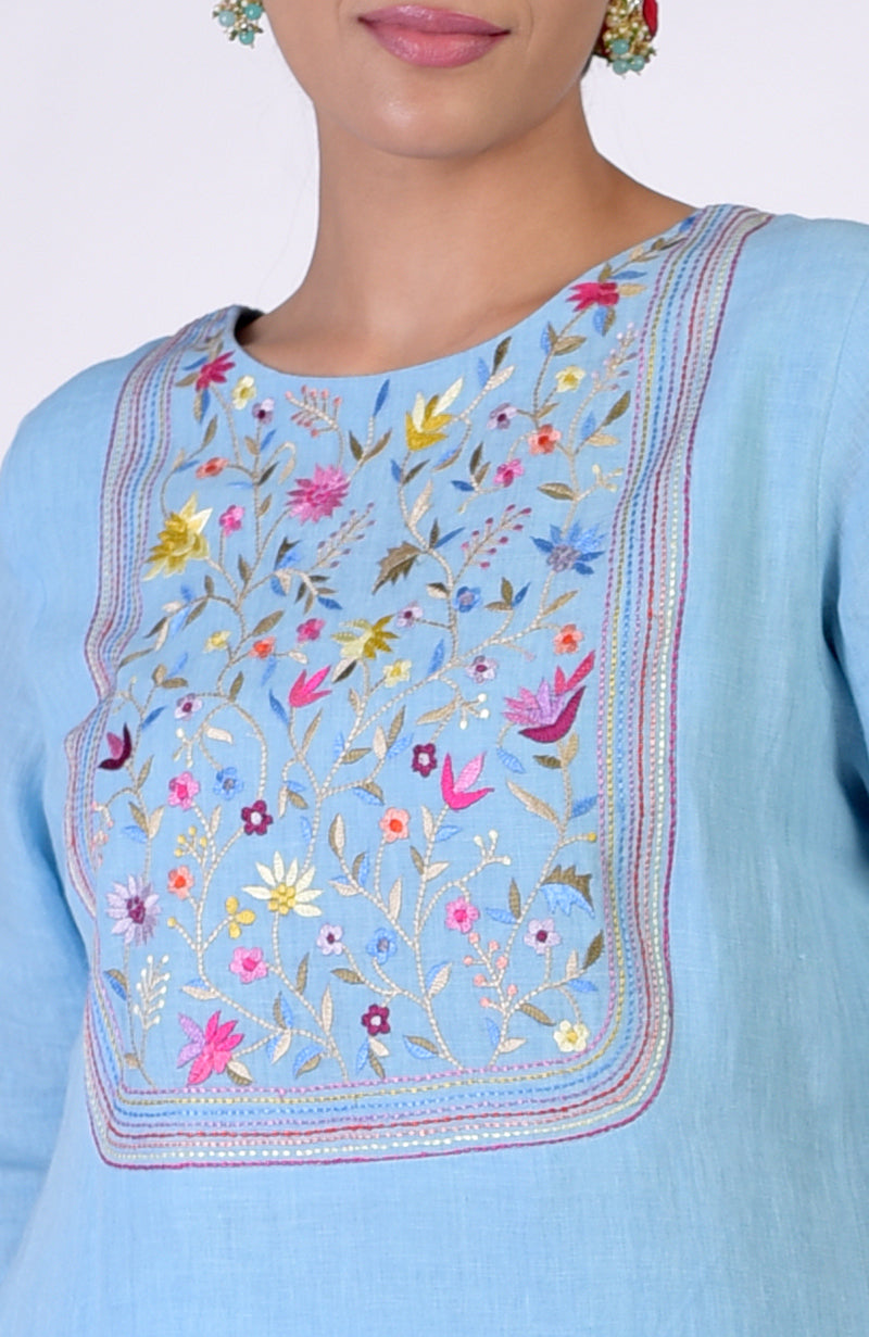 Cerulean blue linen kurta with intricate multi-hued Parsi Gara embroidery on the front.