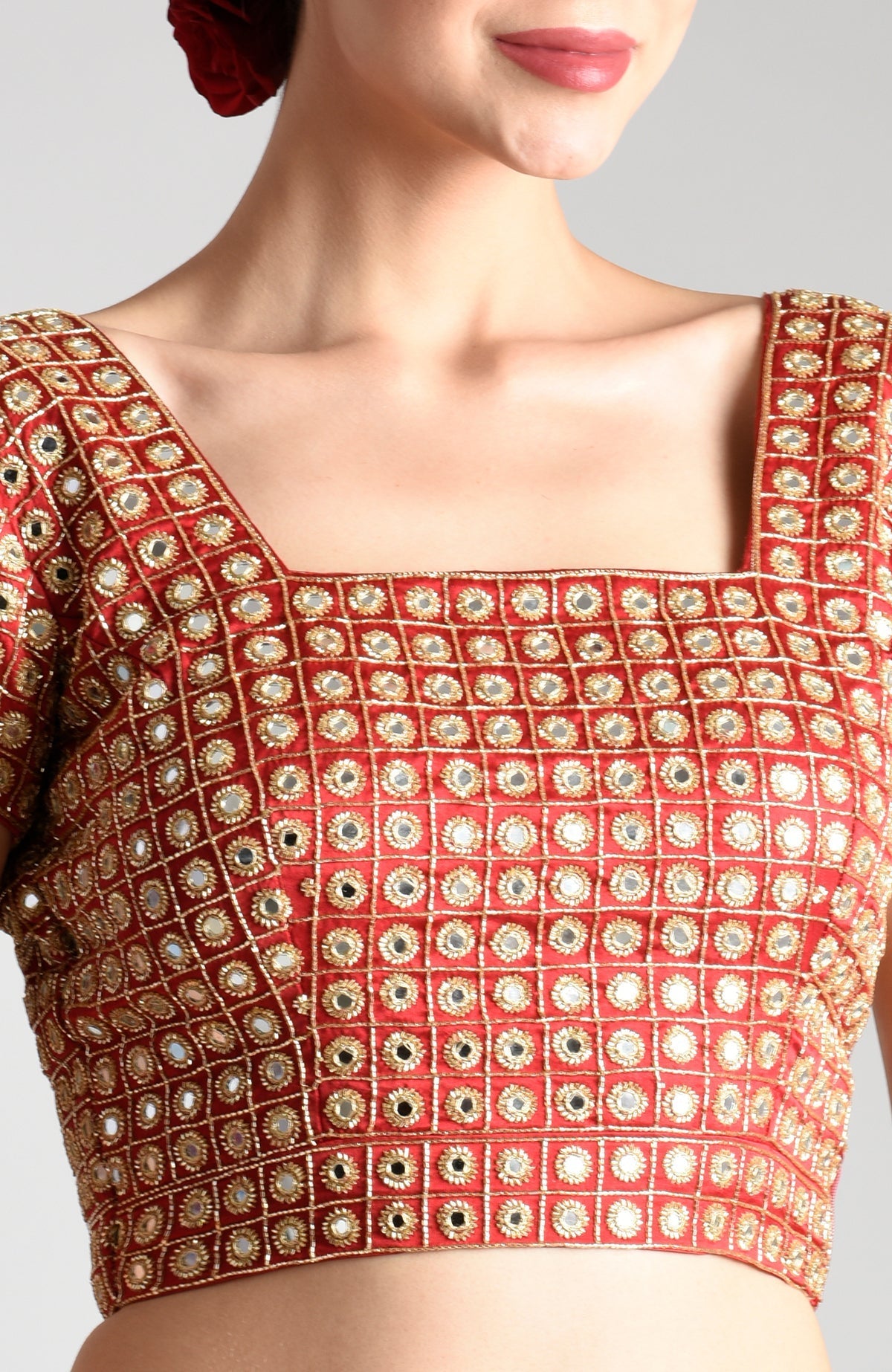 Royal red mirror work and zardozi hand embroidered blouse with a square neckline.