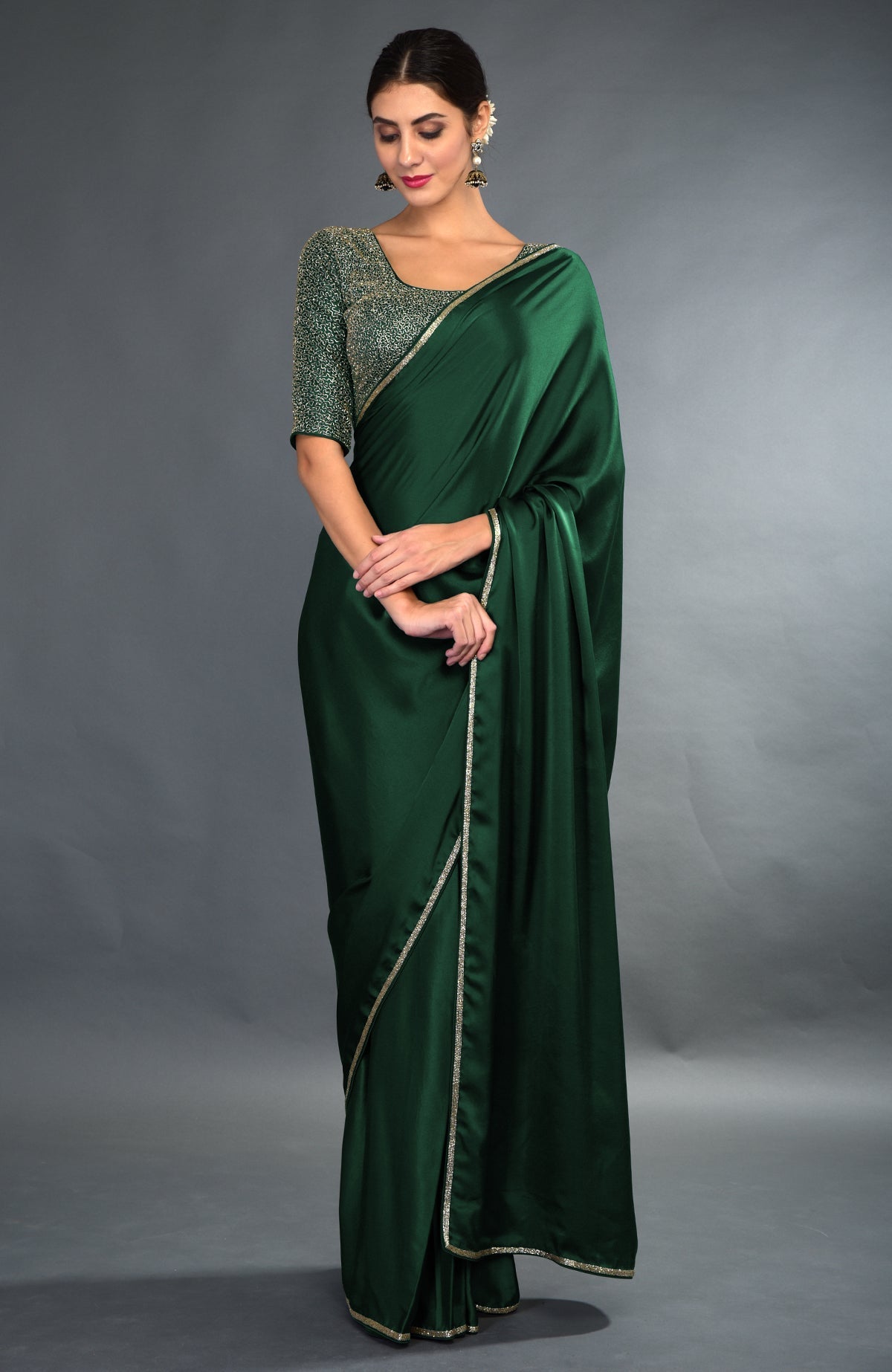 Peacock blue satin saree with gold zardozi borders and an embroidered blouse.