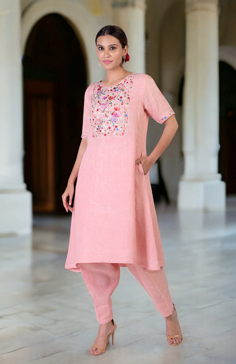 Pink linen kurta set with colorful Parsi Gara embroidery on the neckline and sleeves.