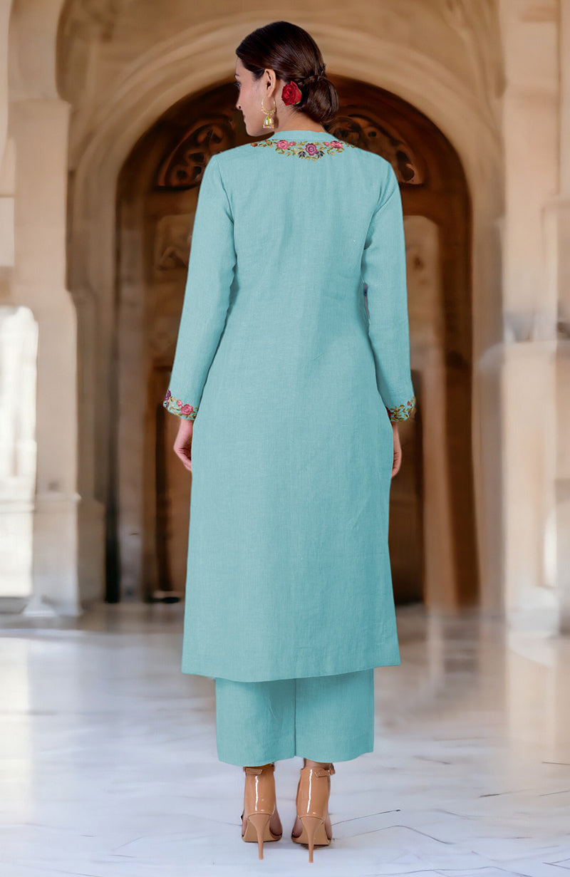 A woman from behind wears an Antigua Sand Parsi Gara embroidered linen kurta set.