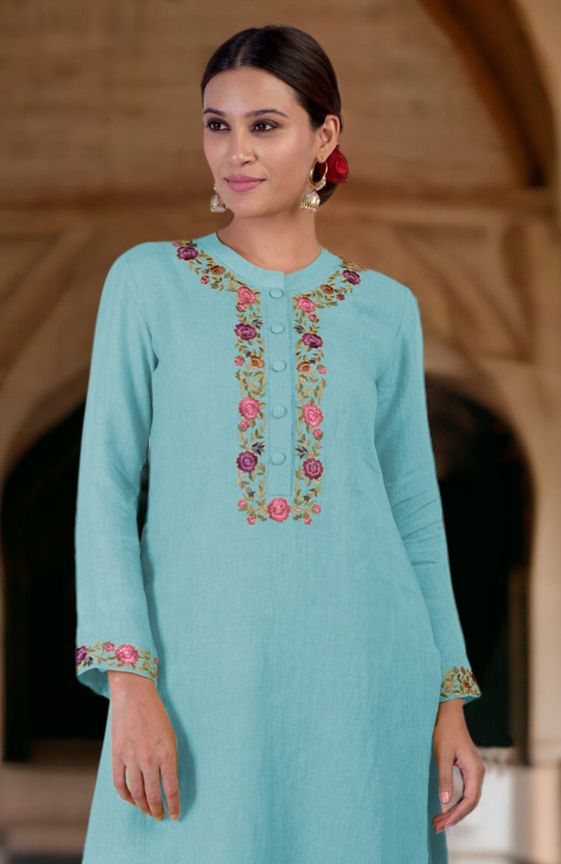 Woman in an Antigua Sand Parsi Gara embroidered linen kurta.