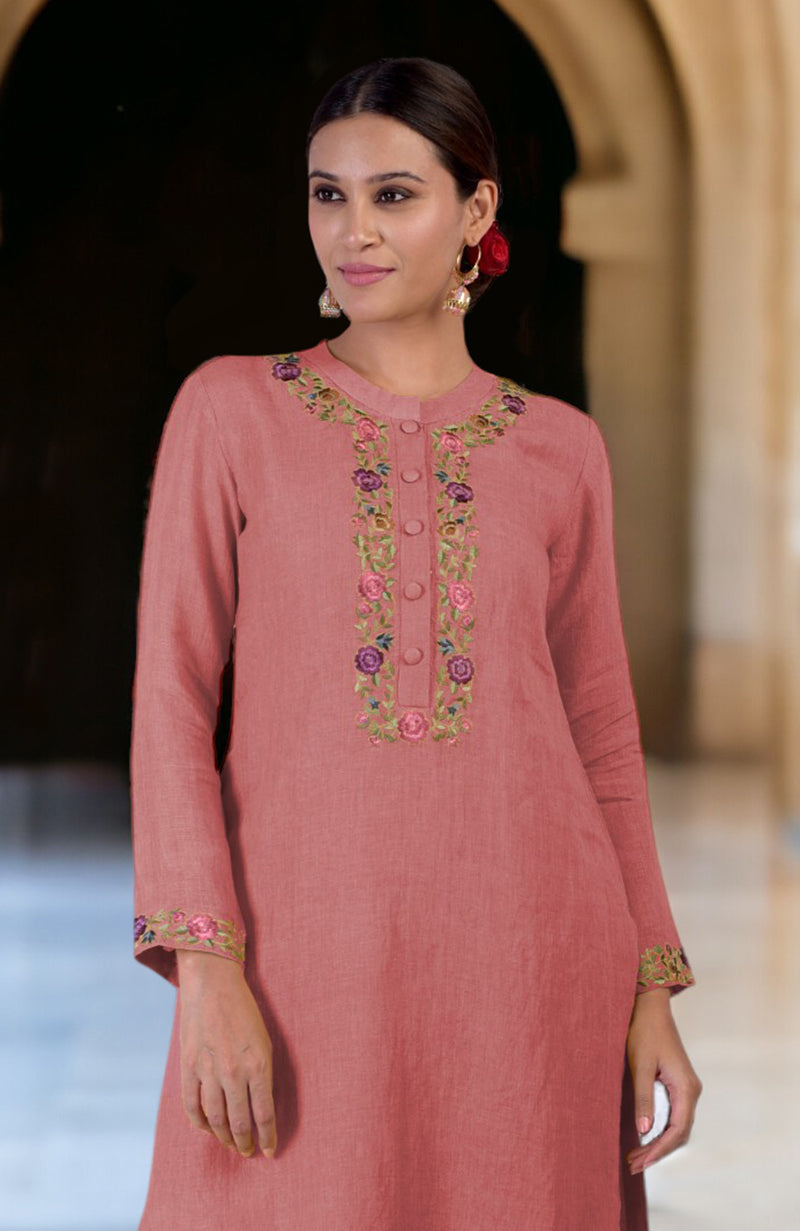 A woman models a desert rose linen kurta with Parsi Gara embroidery.