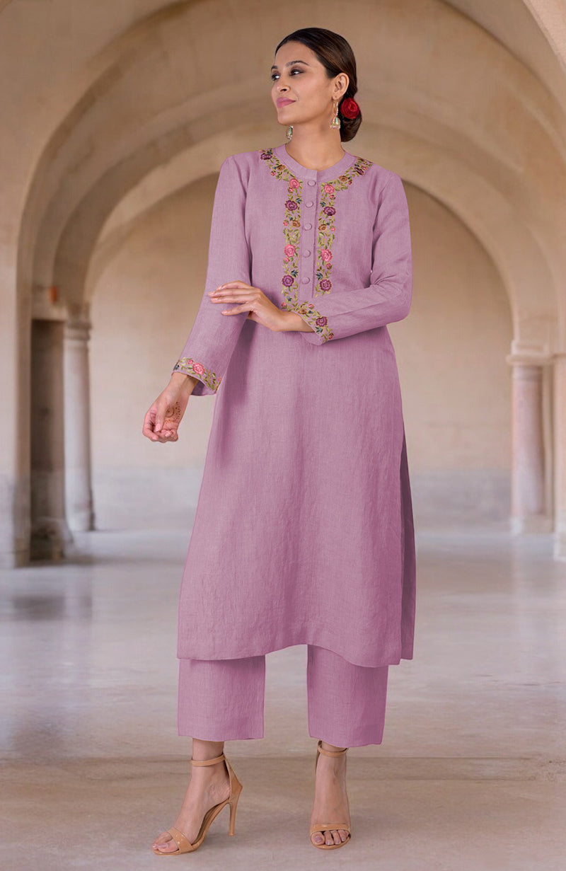 A woman models a smoky grape linen kurta set with Parsi Gara embroidery.