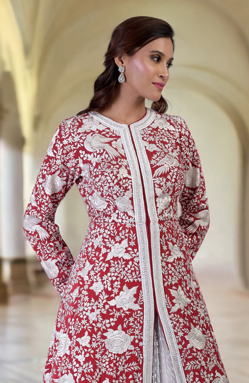 Red Parsi Gara jacket with ivory embroidery and beadwork, paired with an off-white skirt.